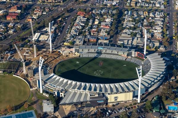 Aerial view of GMHBA Stadium at Kardinia Park in South Geelong, showing construction cranes and earthworks beside the stadium with surrounding streets and housing.