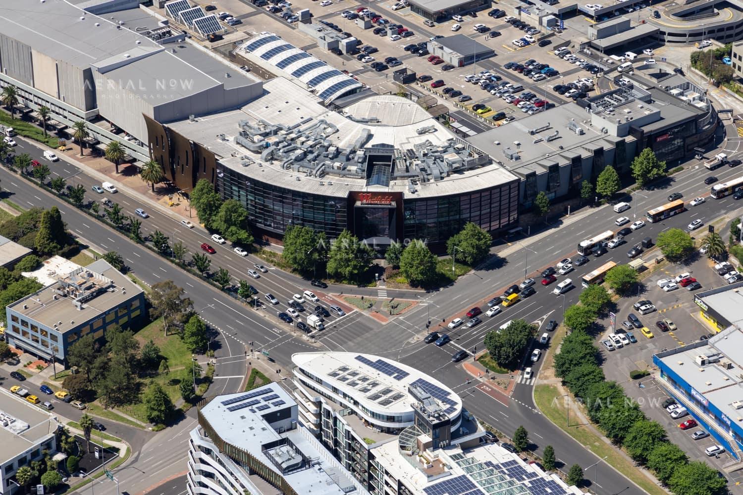 Aerial view of Westfield Doncaster beside the Doncaster Road and Williamsons Road intersection, with traffic, car parks and surrounding commercial buildings visible.