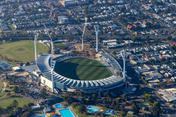 Aerial view of GMHBA Stadium at Kardinia Park in South Geelong, showing the oval, grandstands, light towers, surrounding streets and nearby parkland.