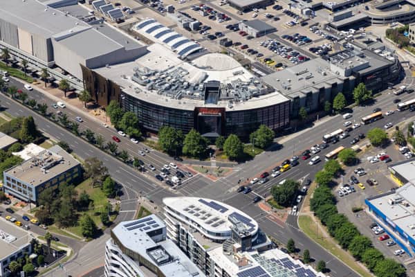 Aerial view of Westfield Doncaster beside the Doncaster Road and Williamsons Road intersection, with traffic, car parks and surrounding commercial buildings visible.